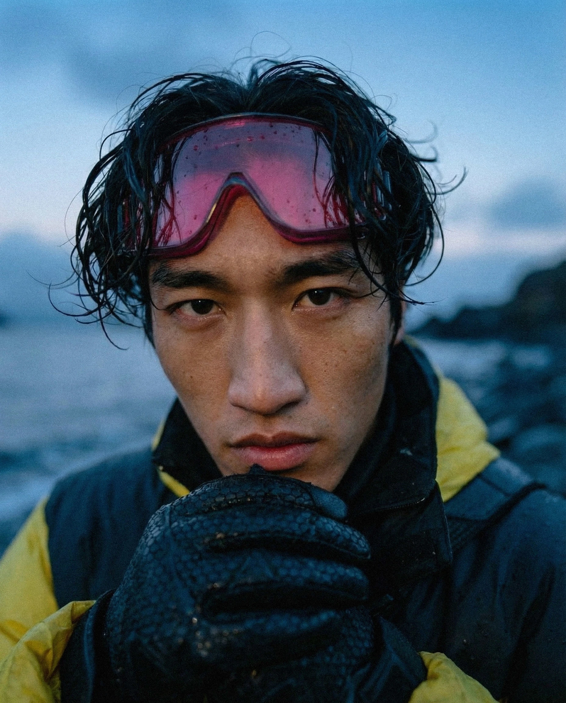 Campaign visual showcasing functional outerwear in real-world, cold coastal conditions
