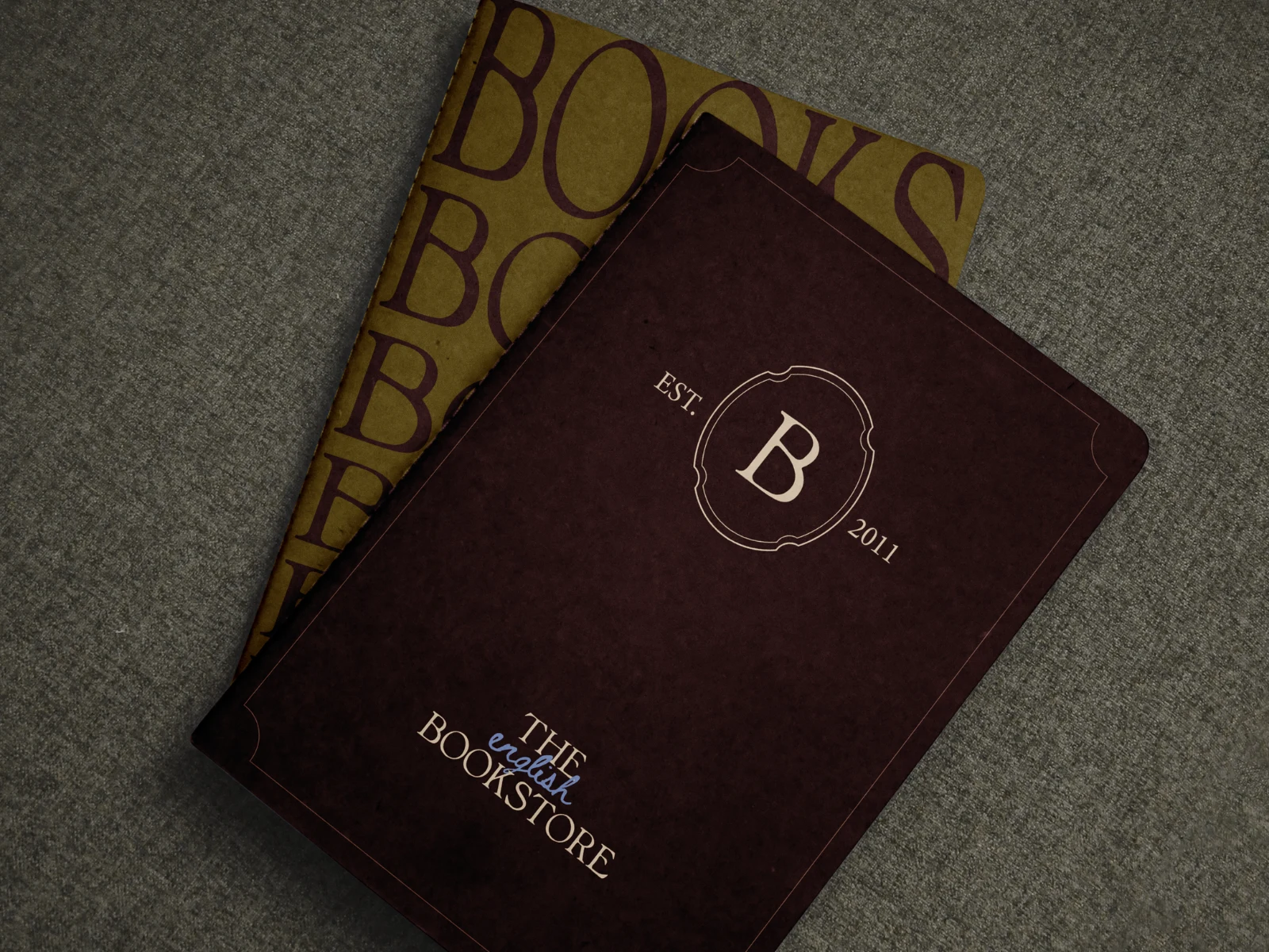 Two notebook designs:
A pair of notebook designs presented in distinct color variations, each incorporating different elements of the brand identity. Both covers use the signature typography and details. Notebooks are thoughtfully chosen to have a function as part of the stationery design — an active invitation into the world of literature, encouraging daily encounters with imagination, stories and written thought.