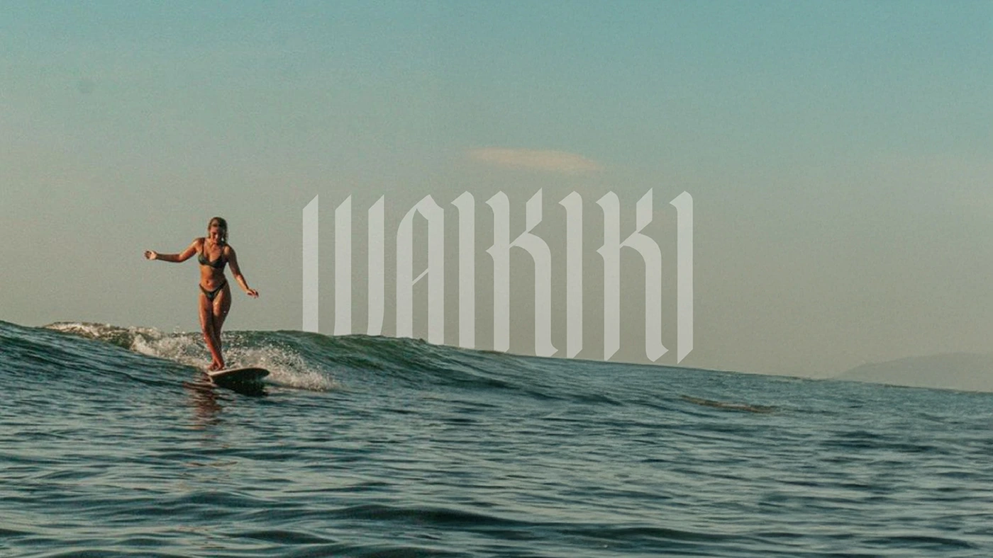 This visual directly connects the typeface's name and its core inspiration. The tall, dynamic forms of the Waikiki font visually mimic the motion and crest of a powerful ocean wave. This application perfectly illustrates the font's ability to be used in high-impact branding and thematic design, successfully blending the classic weight of Gothic script with the adventurous, fluid spirit of surf culture.