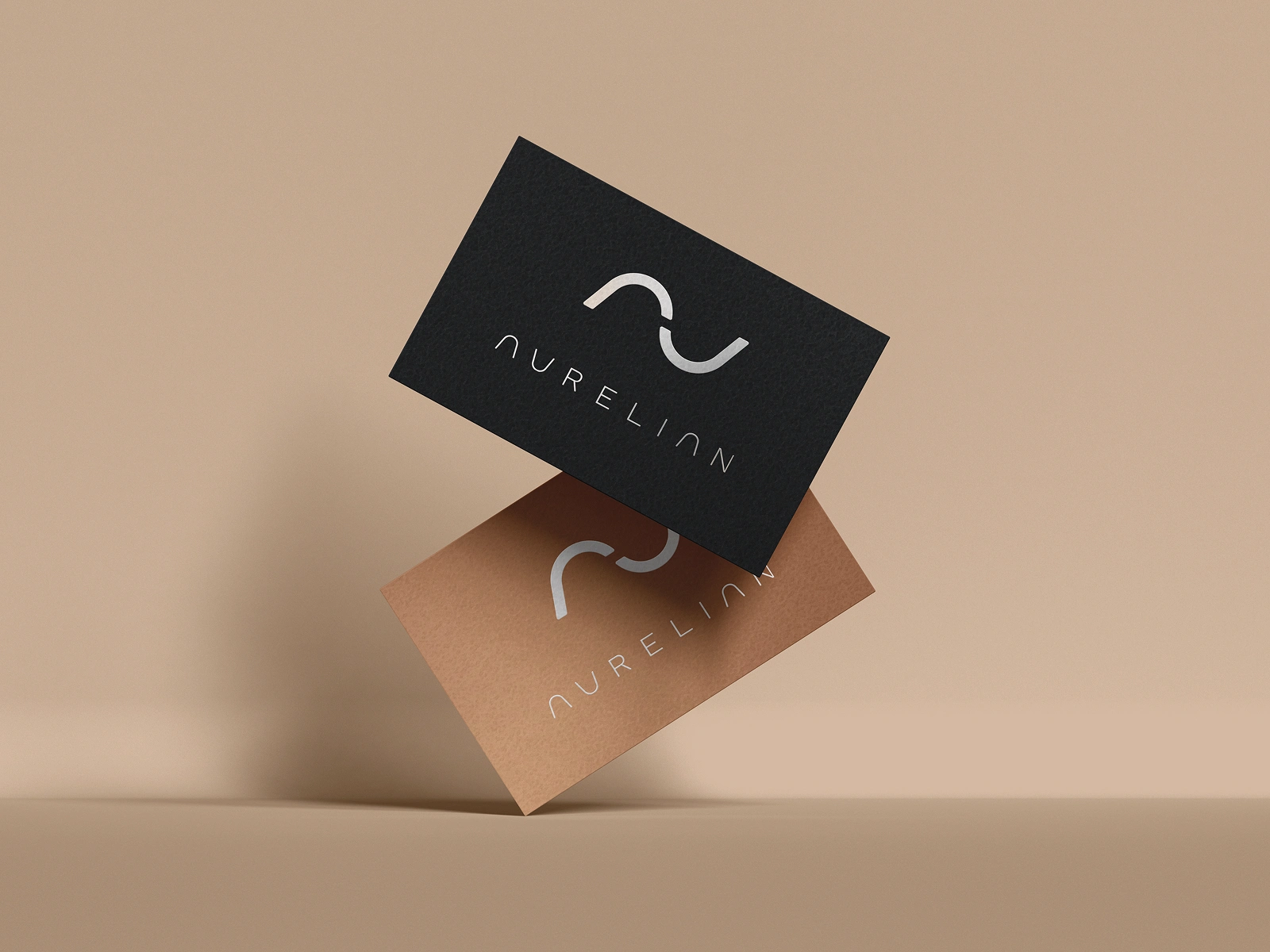 Business card design — metallic foil stamping and warm material tones conveying exclusivity and tactile quality.