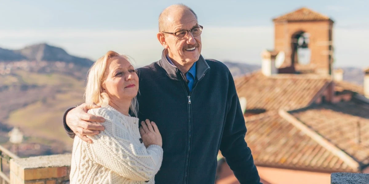 a happy couple enjoying a trip to Italy, having purchased travel insurance for Italy
