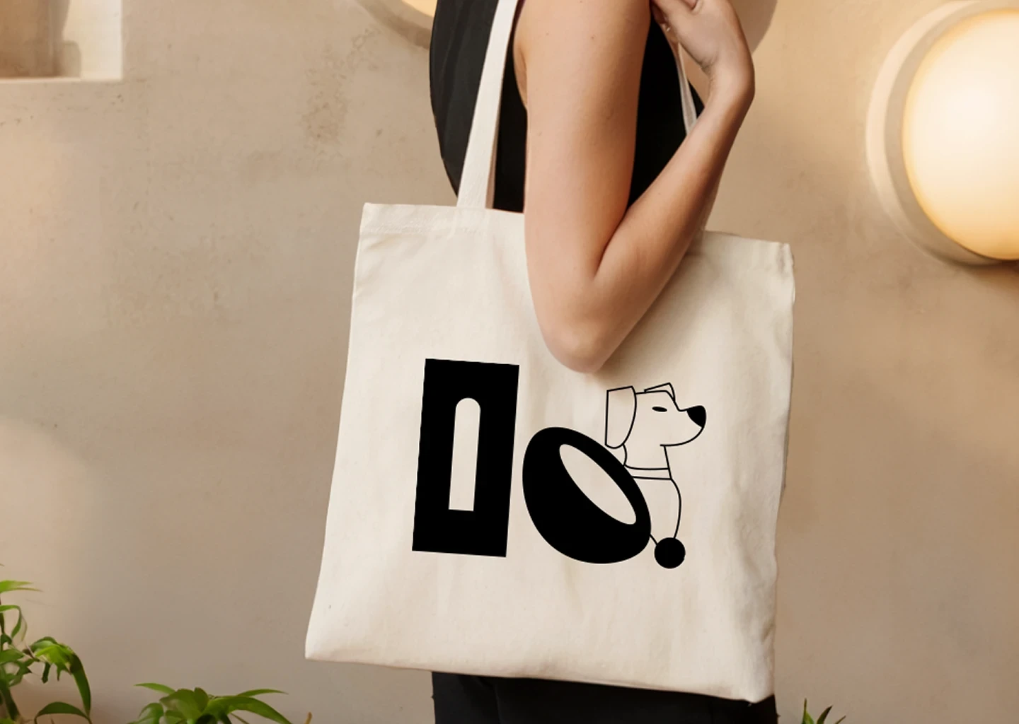 Beige tote bag with black Clay & Bean logo design featuring a minimal line art dog illustration.