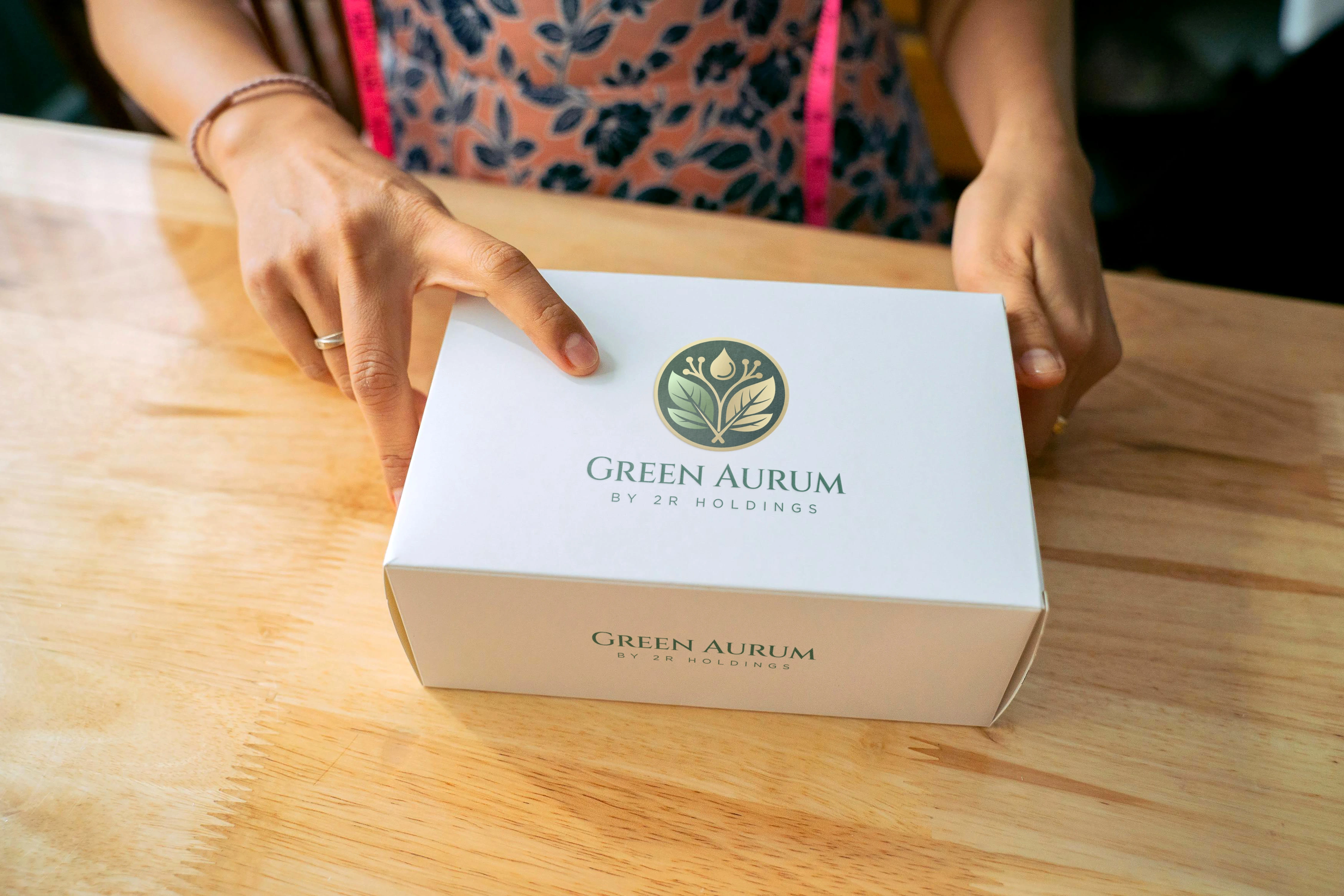 A branded product box being presented, highlighting the clean and sophisticated packaging.