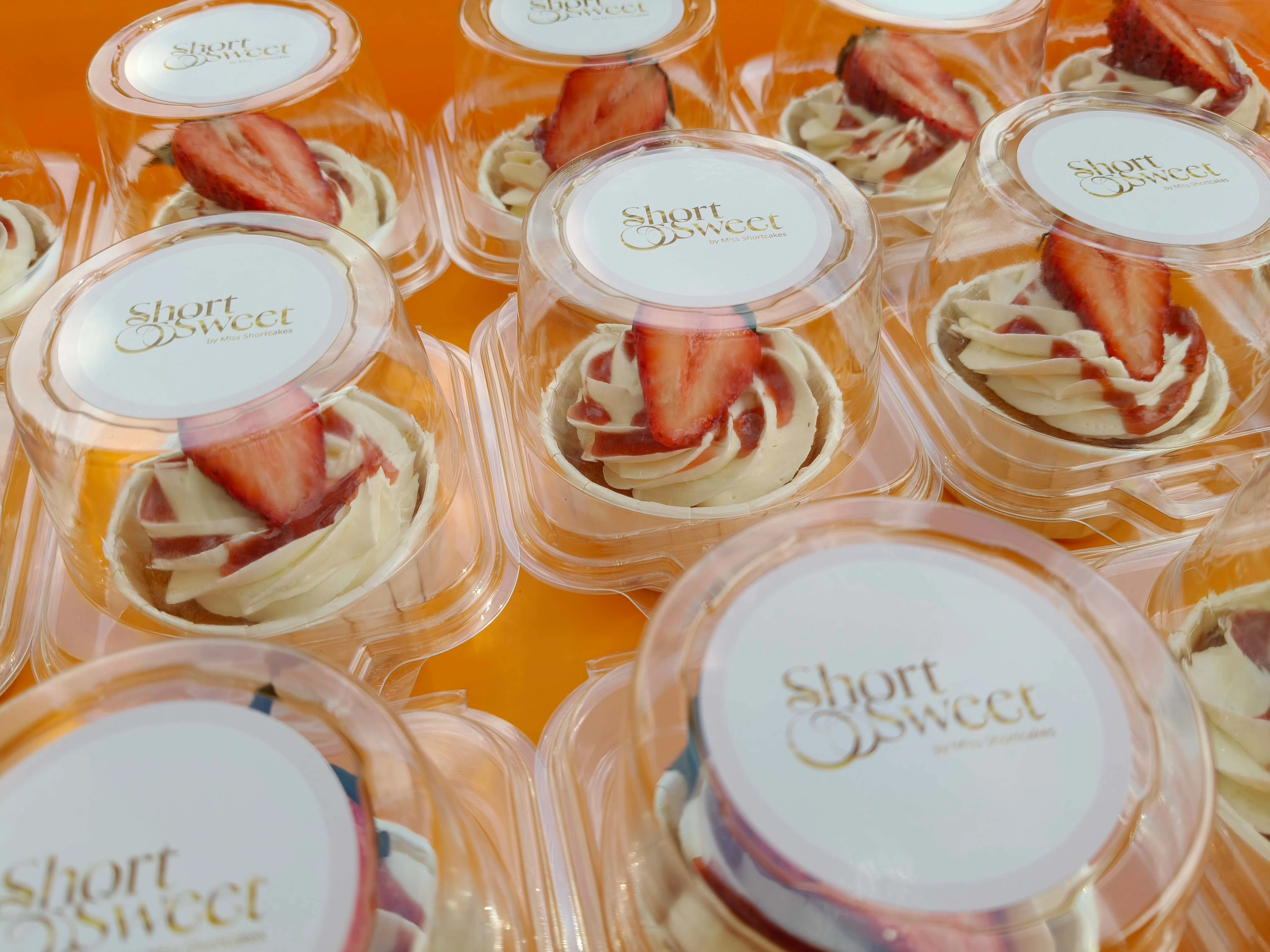 A shot of cupcakes lined up with the sticker on it
