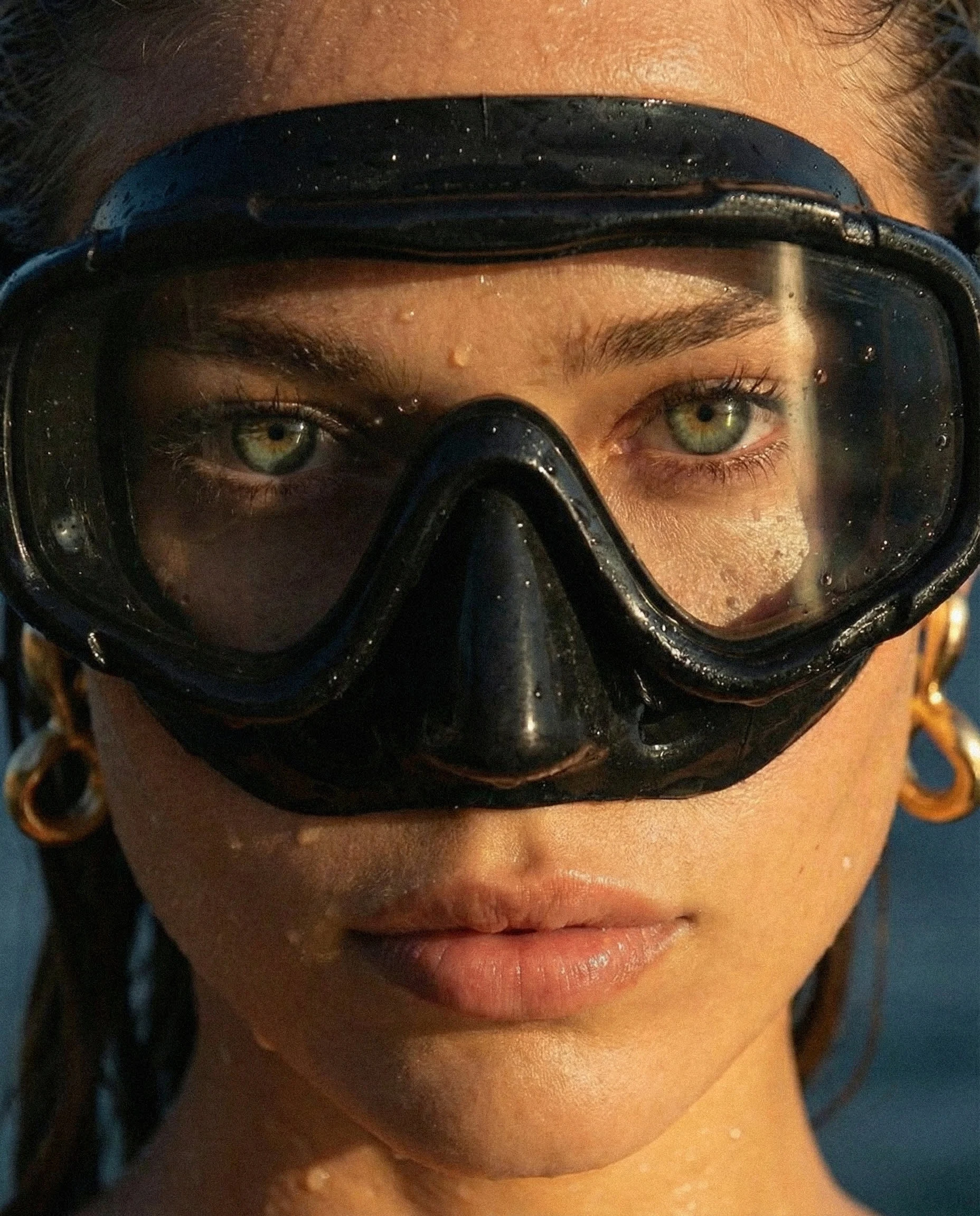 Extreme close-up capturing skin, water, and natural light in raw detail.