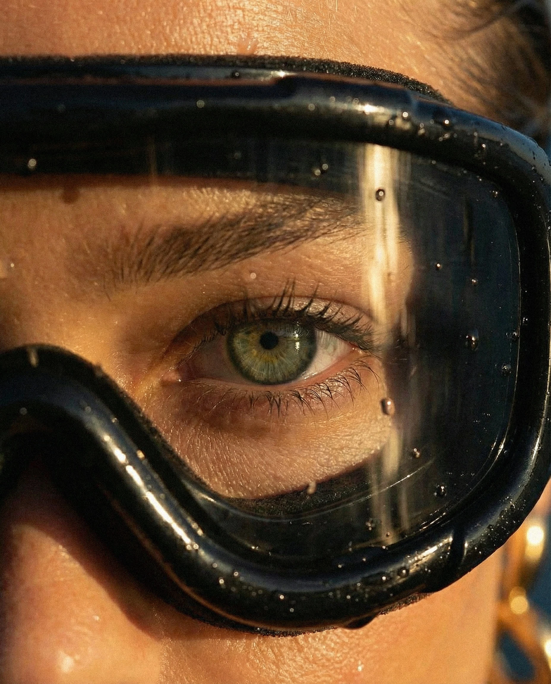 Extreme close-up capturing skin, water, and natural light in raw detail.