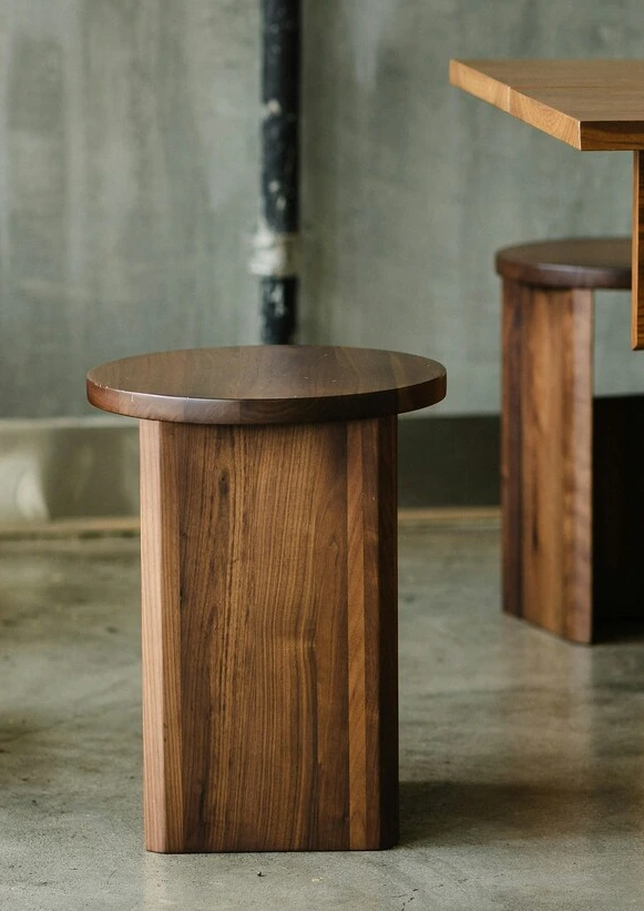 **Minimalist handcrafted wooden stool with clean lines and warm tones.**
