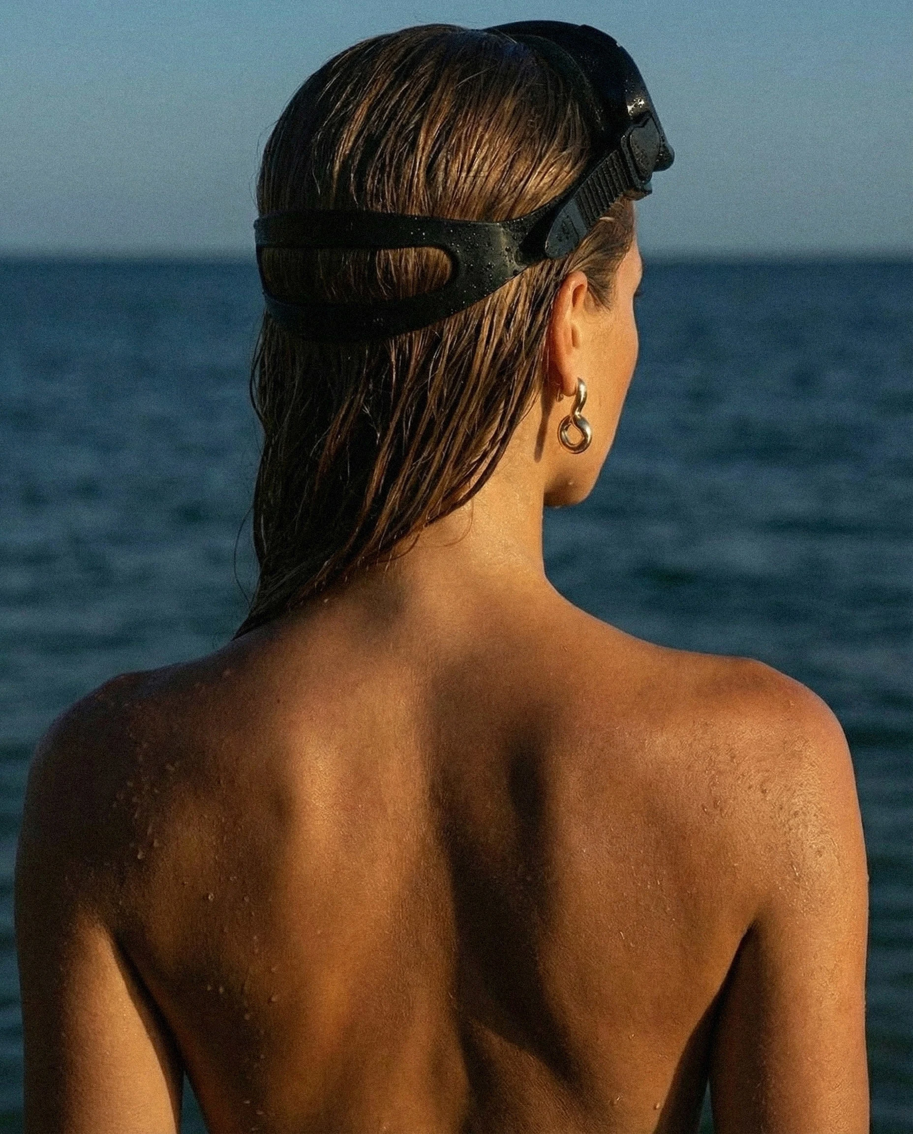 Extreme close-up capturing skin, water, and natural light in raw detail.