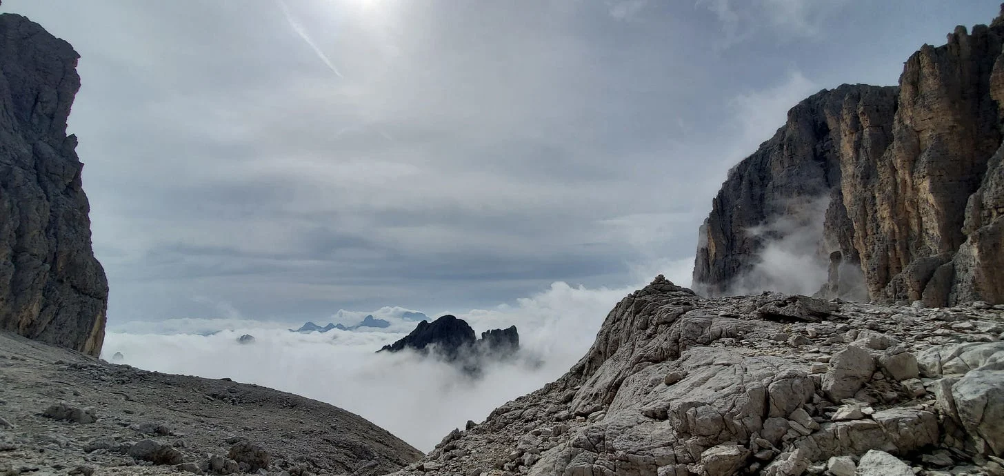 Coming down from a high mountain pass above the clouds on the AV-2 Route in Italy’s Dolomites feels fitting for the imagery described above.