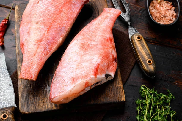 Parts of a Red Bream Fish on a wooden cutter