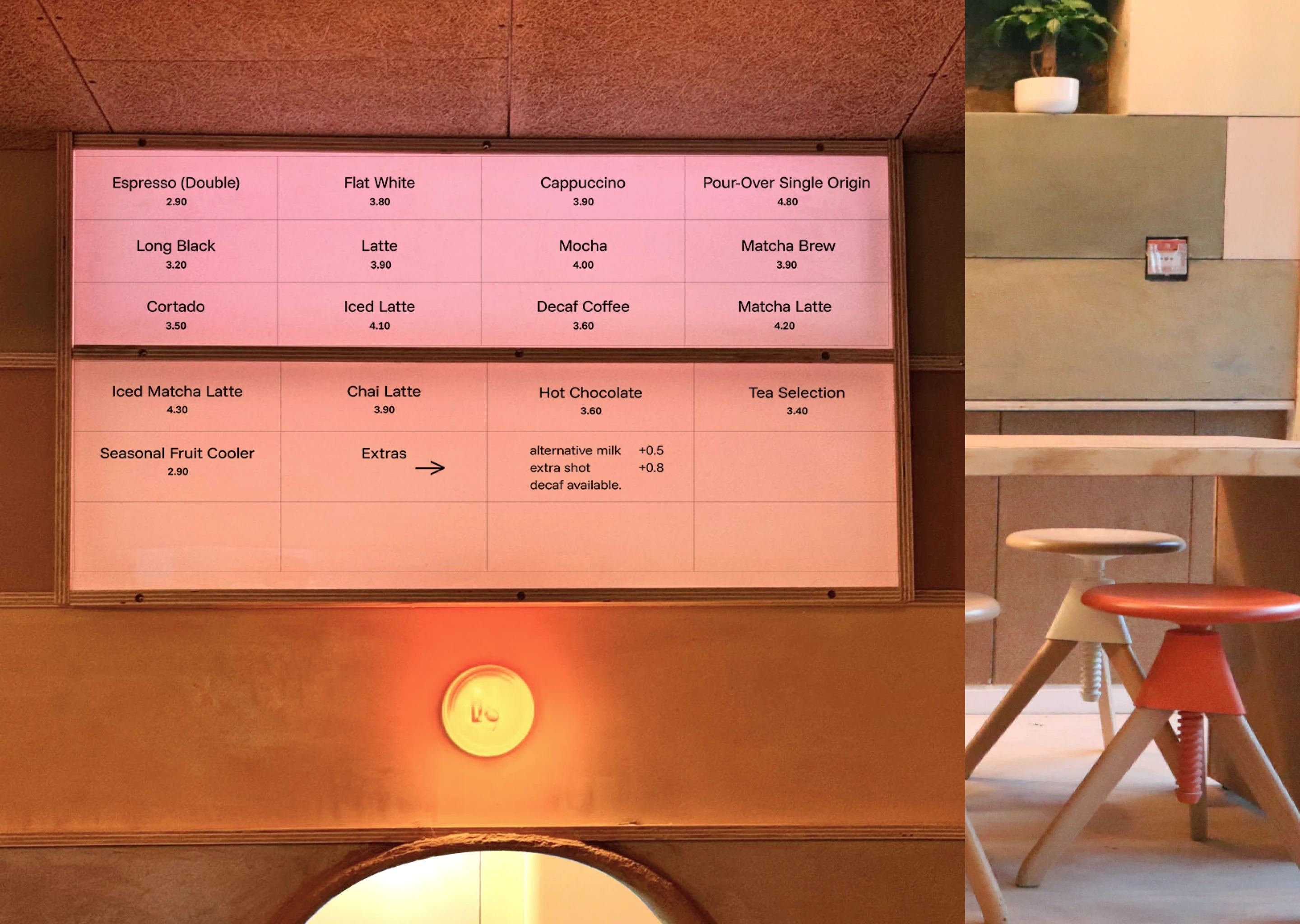 Clay & Bean café menu board displaying coffee, tea, and seasonal drinks, with warm interior design elements.