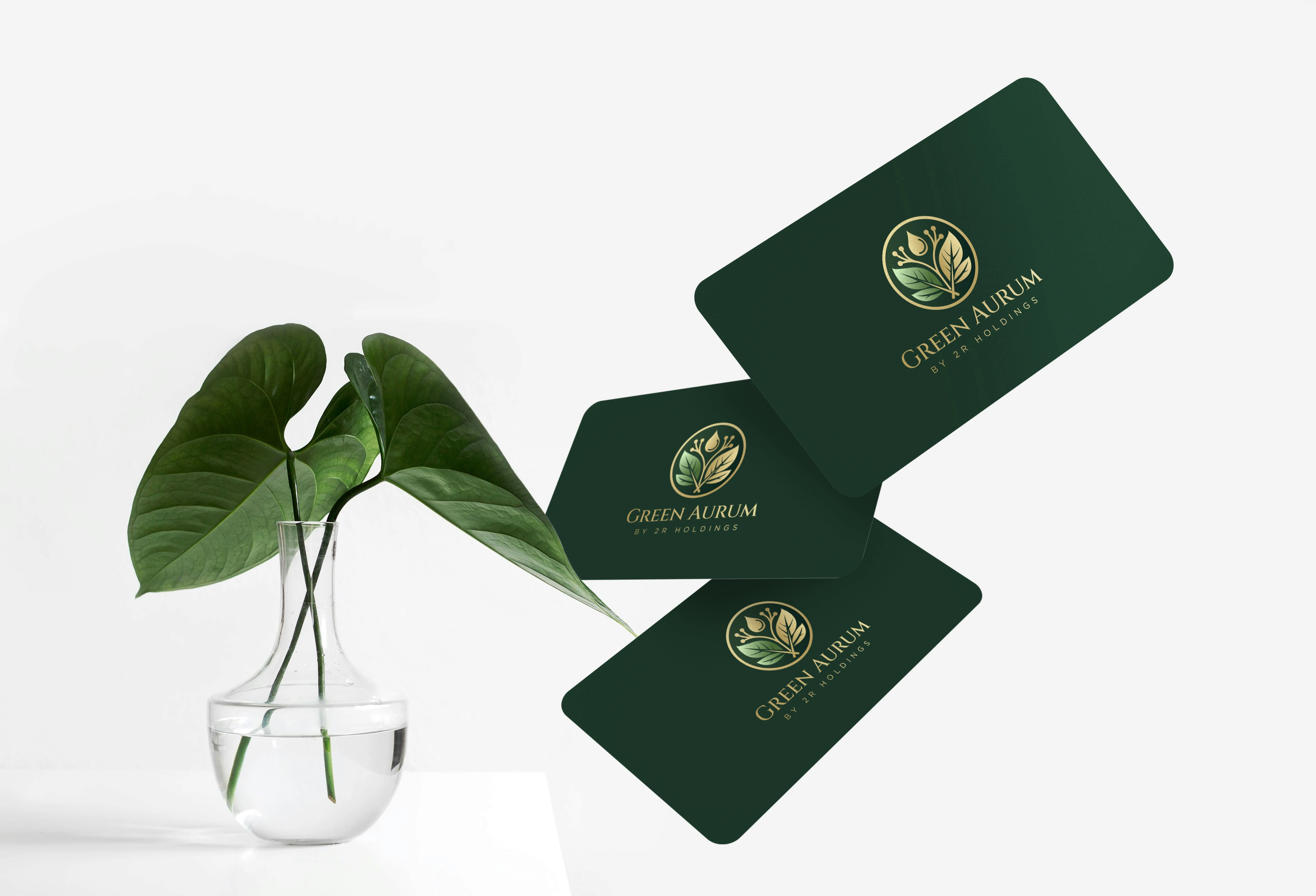 Three business cards featuring the Green Aurum logo, emphasizing a modern and natural aesthetic.