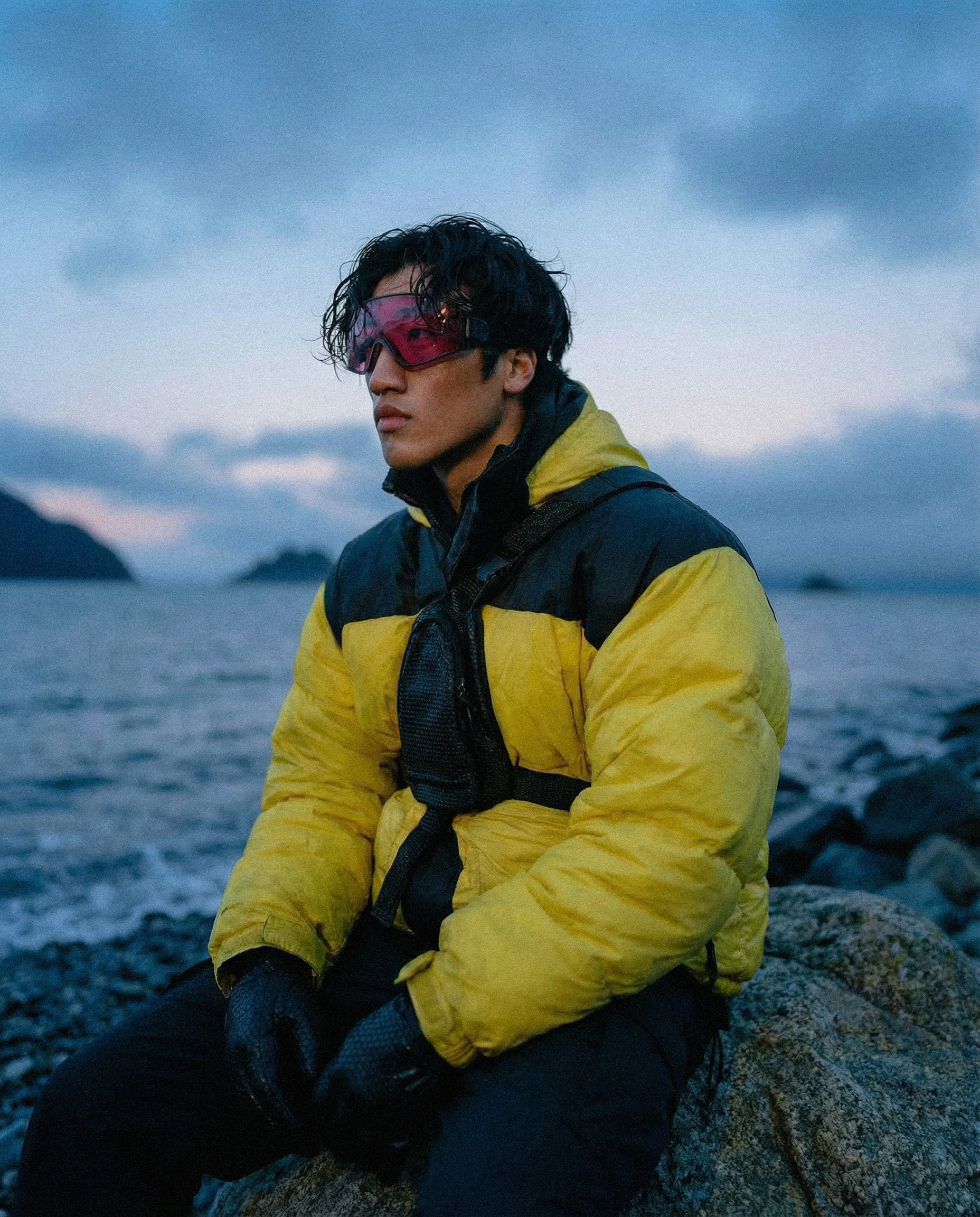 Campaign visual showcasing functional outerwear in real-world, cold coastal conditions