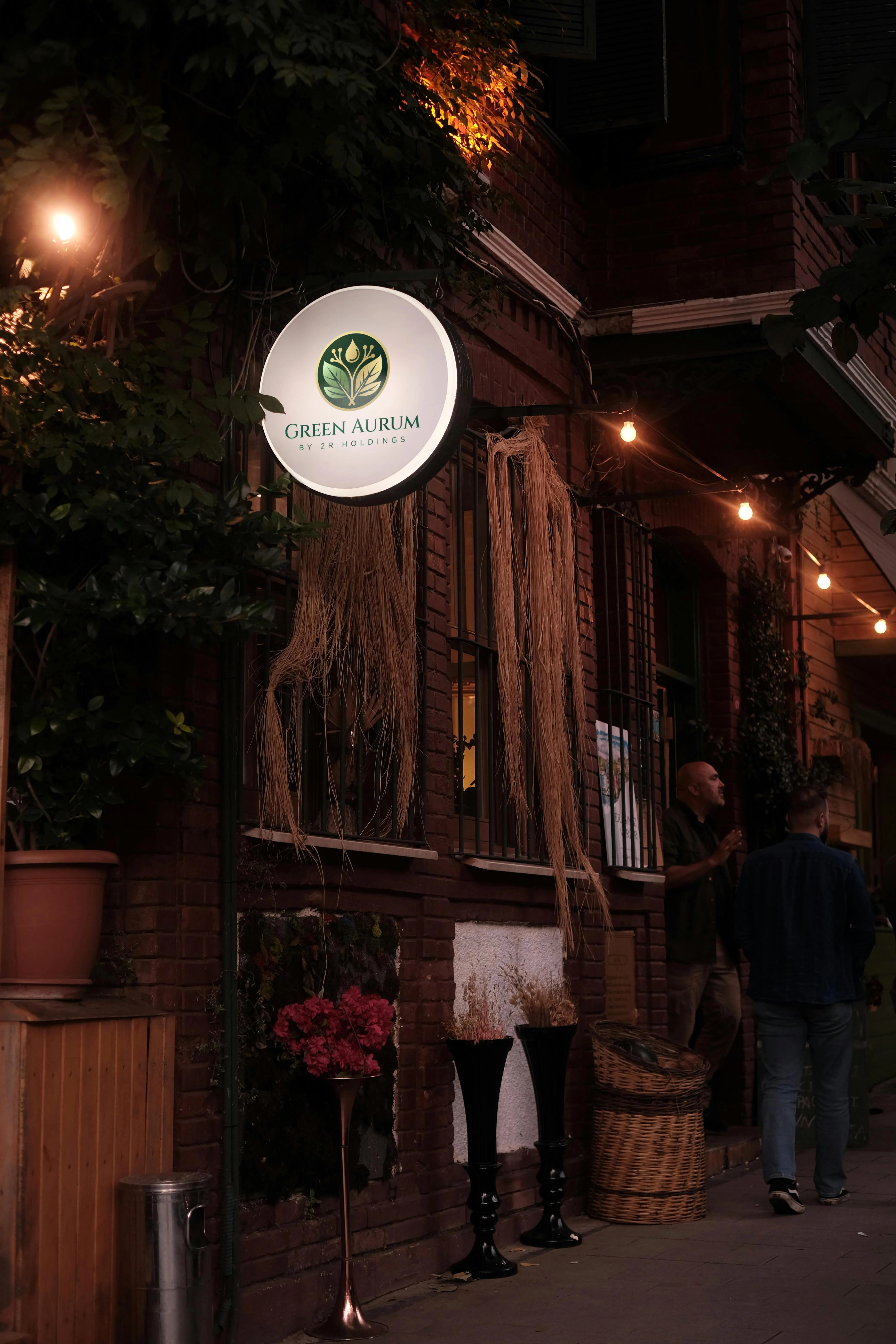 The brand's illuminated outdoor sign, creating a warm and inviting presence.
