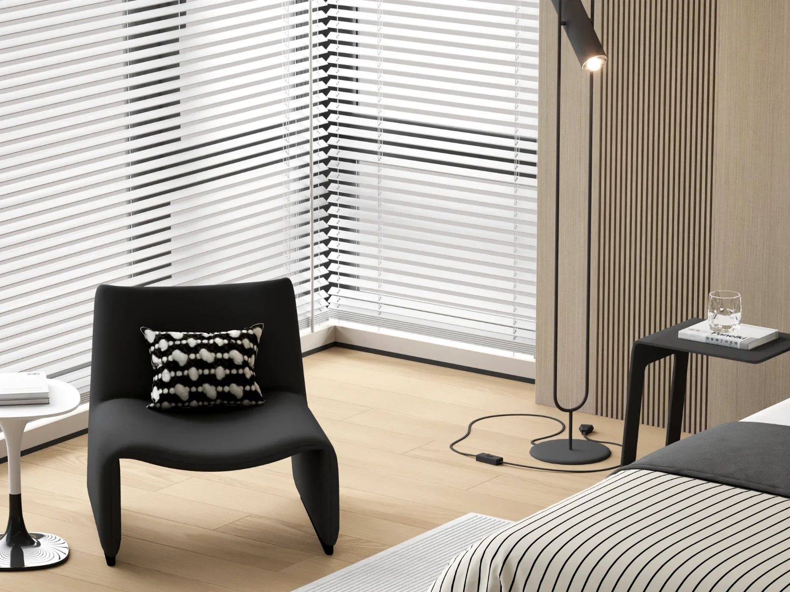The design features a custom upholstered bed with striped bedding, layered pillows, ambient strip lighting, and curated furniture including a sleek accent chair and floating side tables.