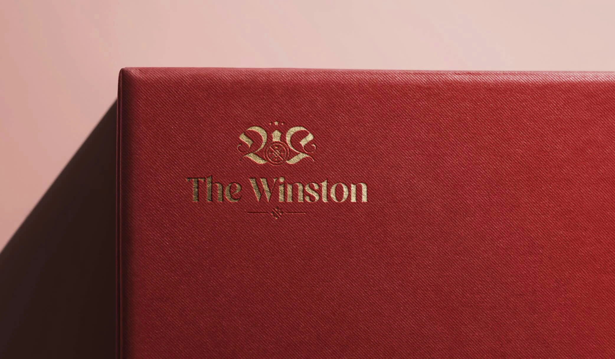 The logo printed using gold letterpress on a Megan colored box with texture, to show how the brand's aesthetic can be applied in packaging and other physical materials.