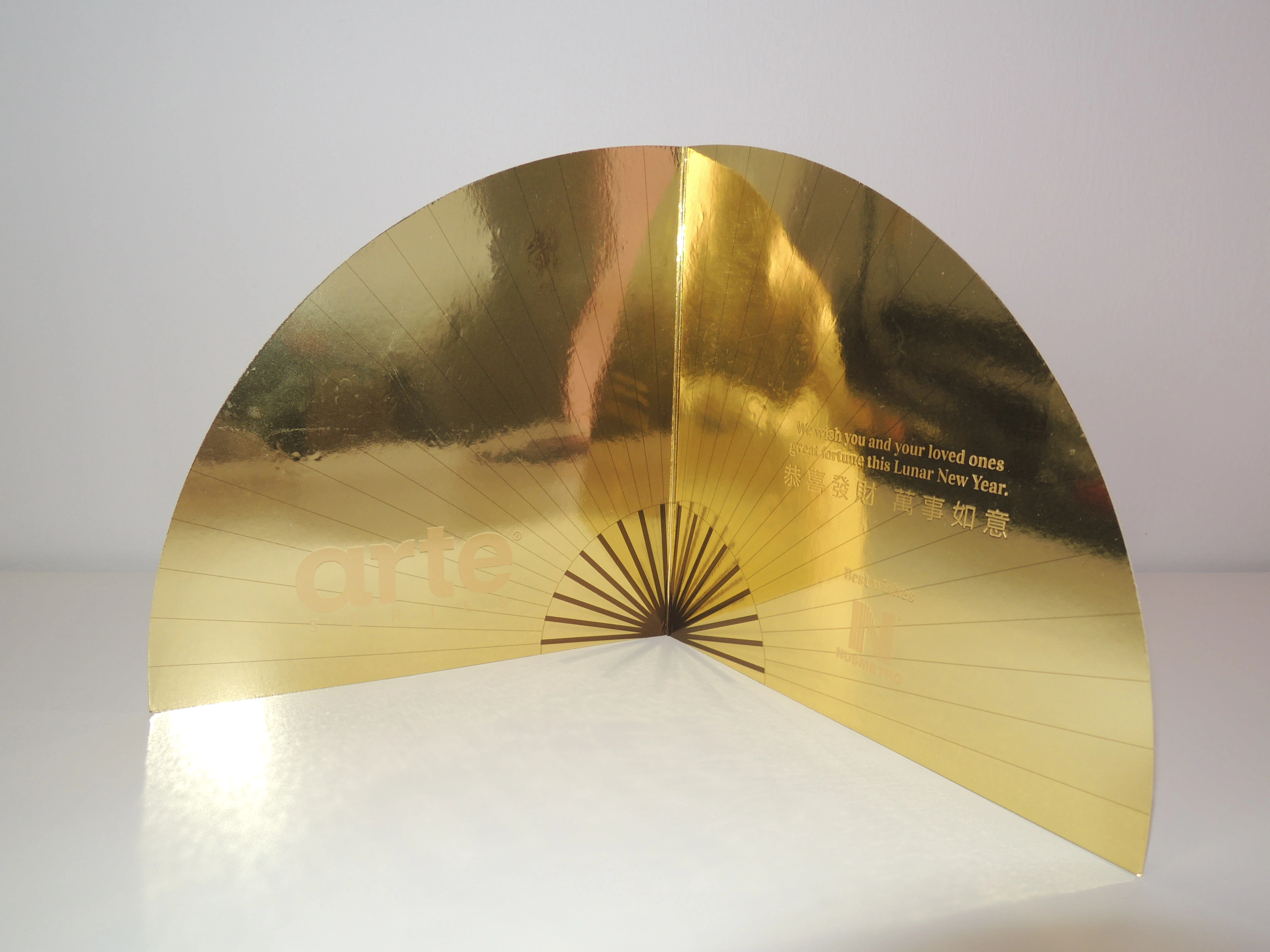 The final print of the dynasty fan greeting card was made of reflective gold paper