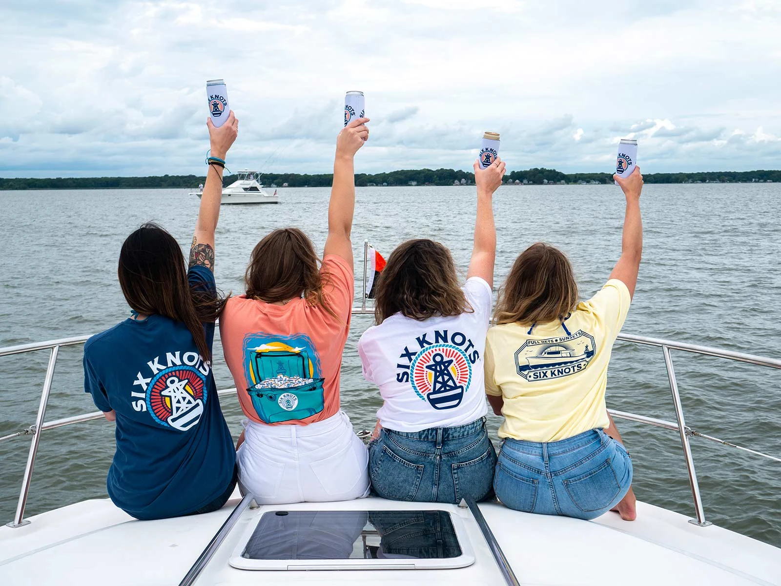 Four individuals repping Six Knots t-shirts on the Chesapeake Bay