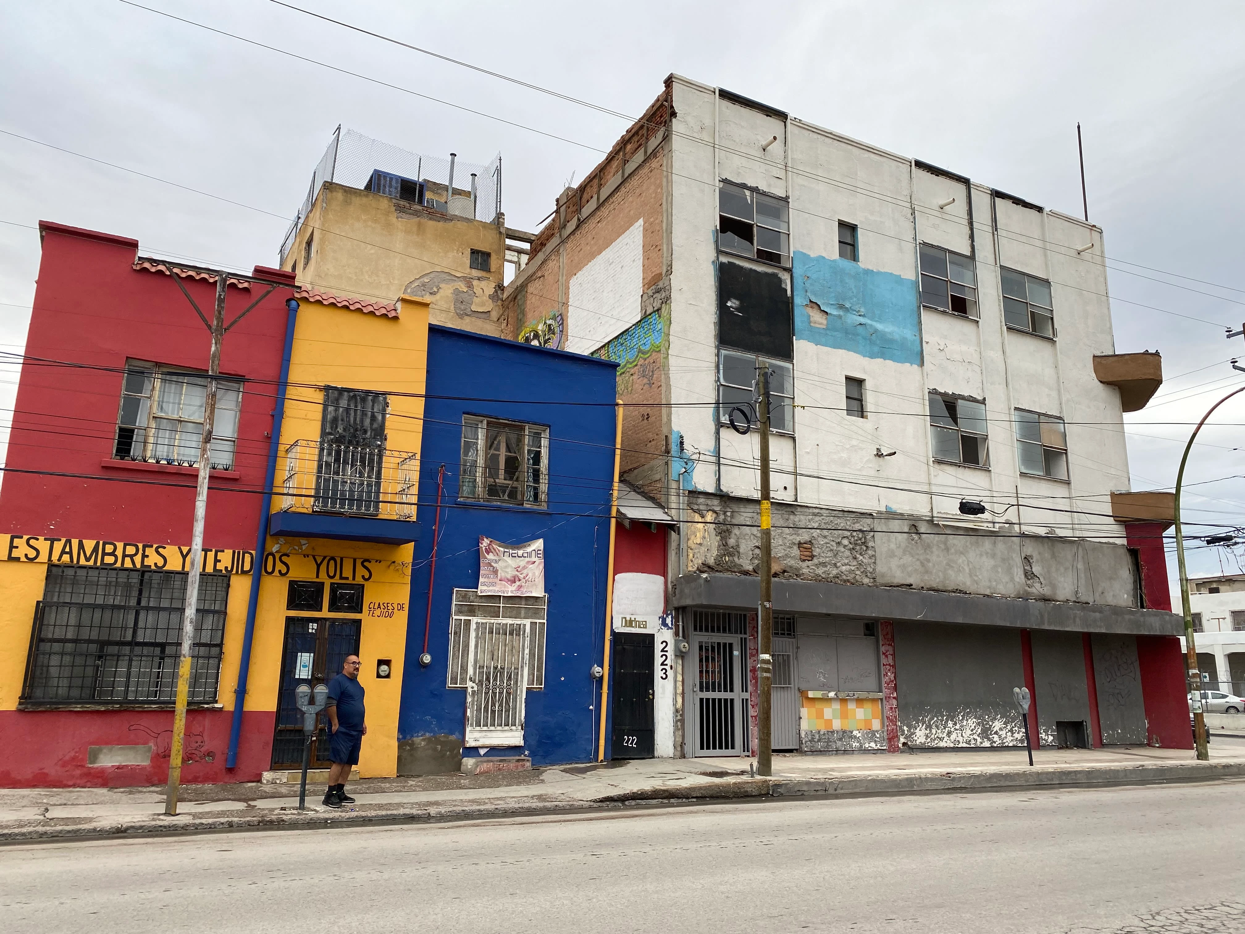 A street view of Casa de Colores (the blue and white building on the right) in Ciudad Juárez, Mexico. Casa de Colores was a shelter that provided safety and community to 45 transgender women seeking asylum in the U.S.  Photo By Kallie Cox.