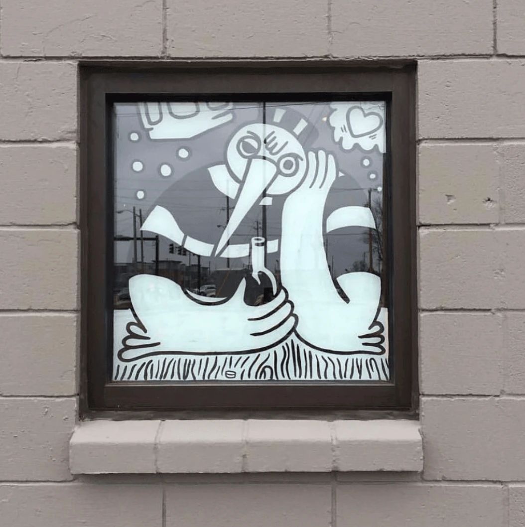 Mural design showing through the window from the exterior of Jailbird.