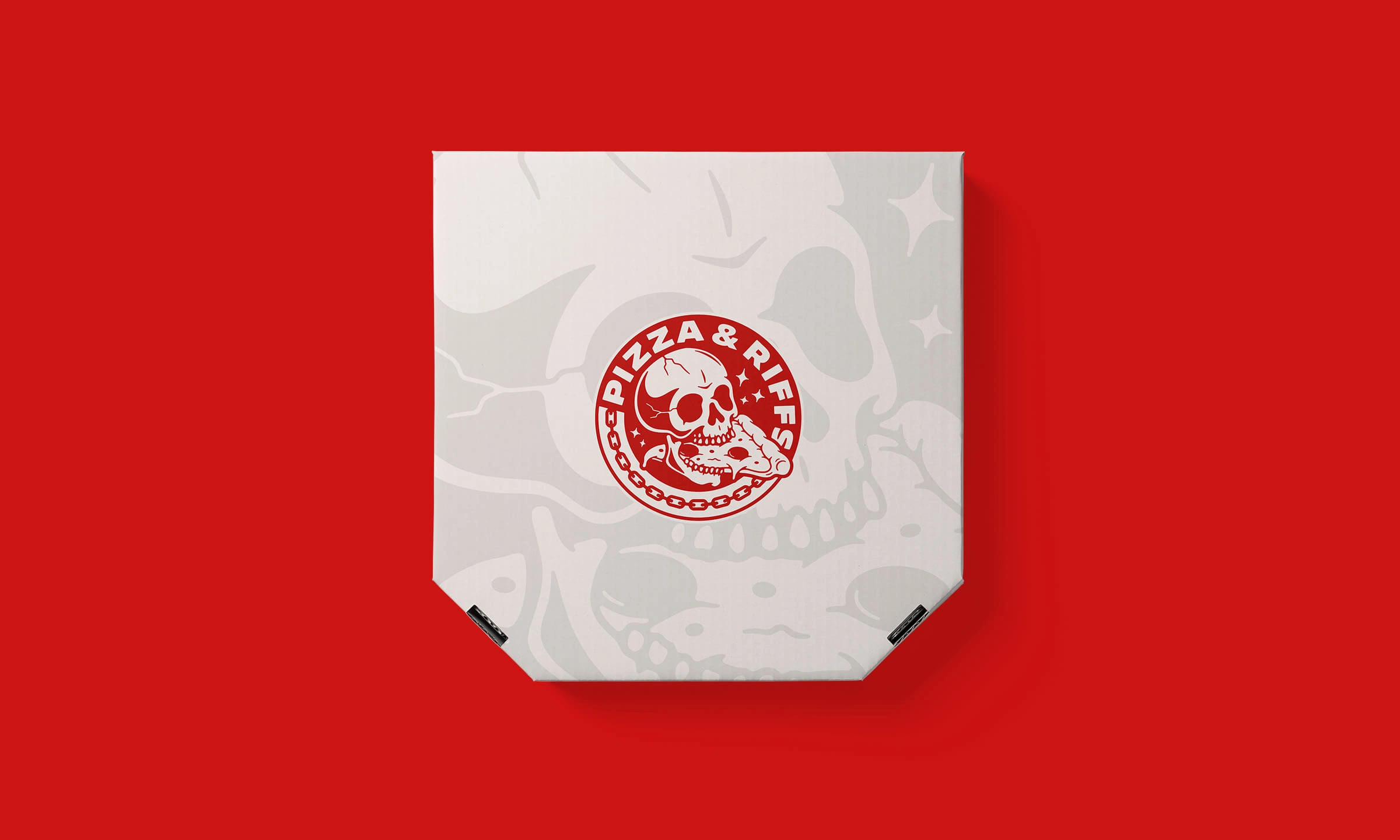 Custom pizza box with the Pizza & Riffs branding, featuring a subtle skull motif for a rebellious touch.