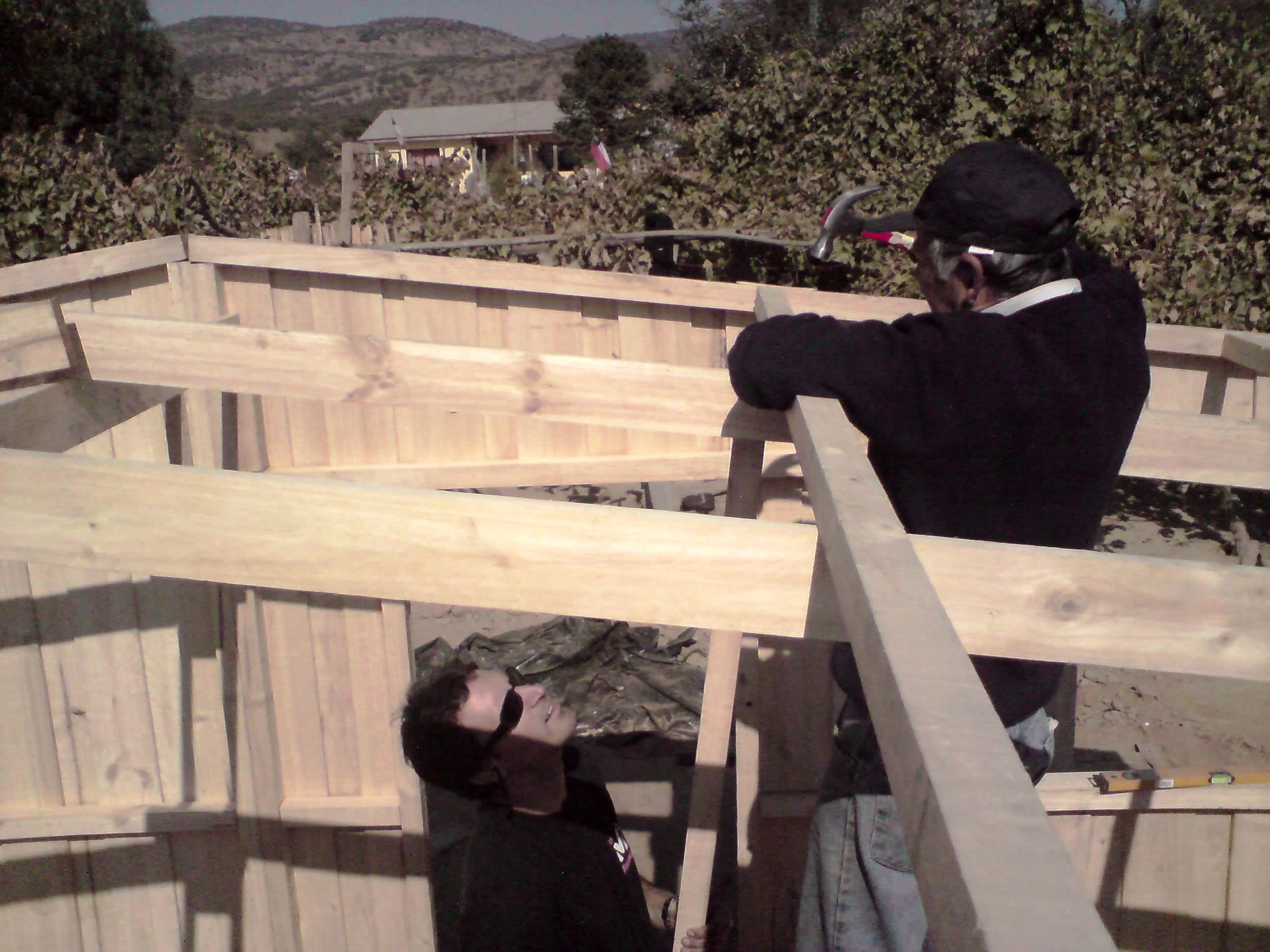 Don Antonio and Marc installing rafters off the secondary beams at Los Coipos, April 2010. Photo by Ben Angel.