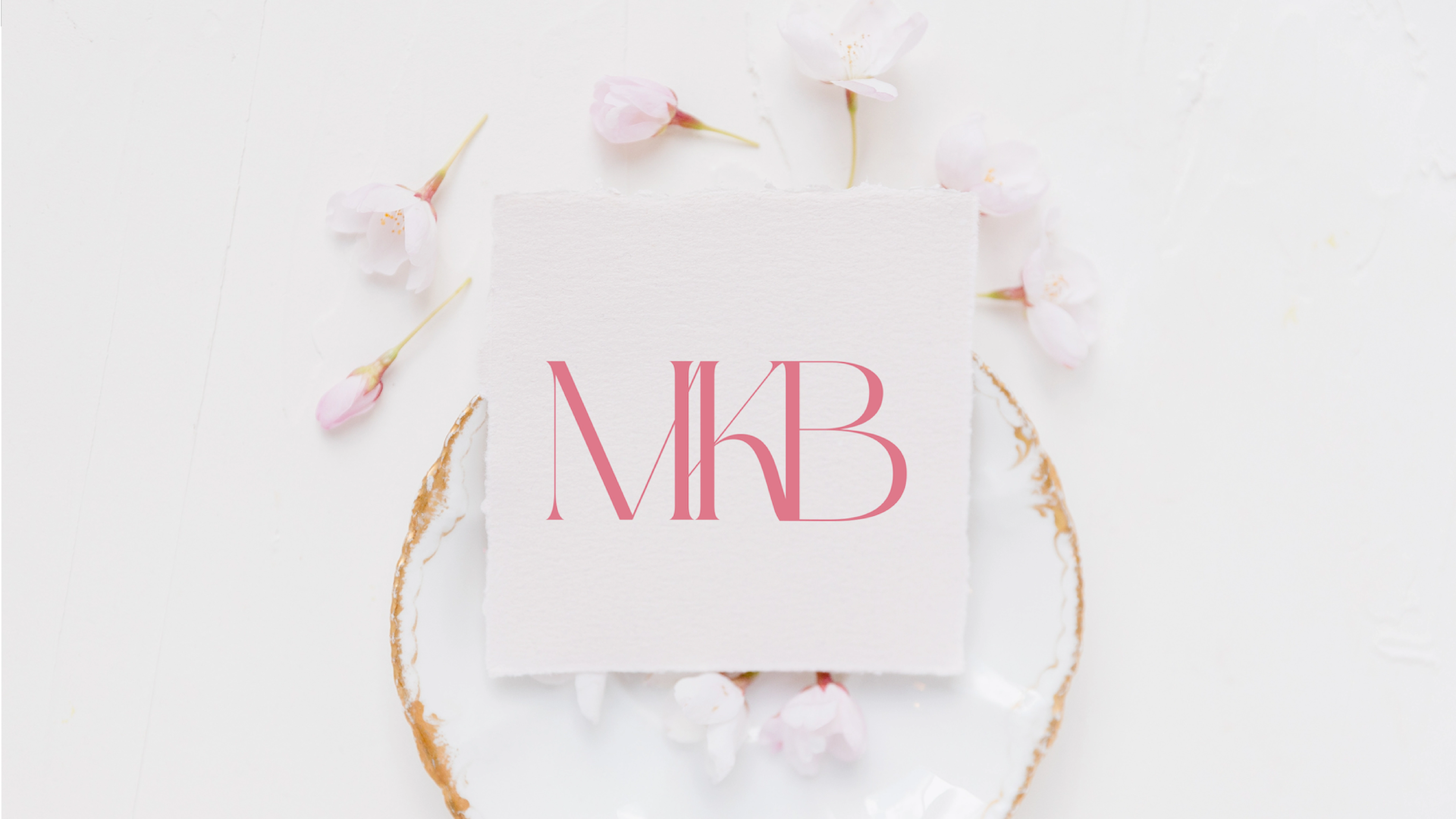 An image showing a card on a gold-rimmed plate showcasing the brand MKB