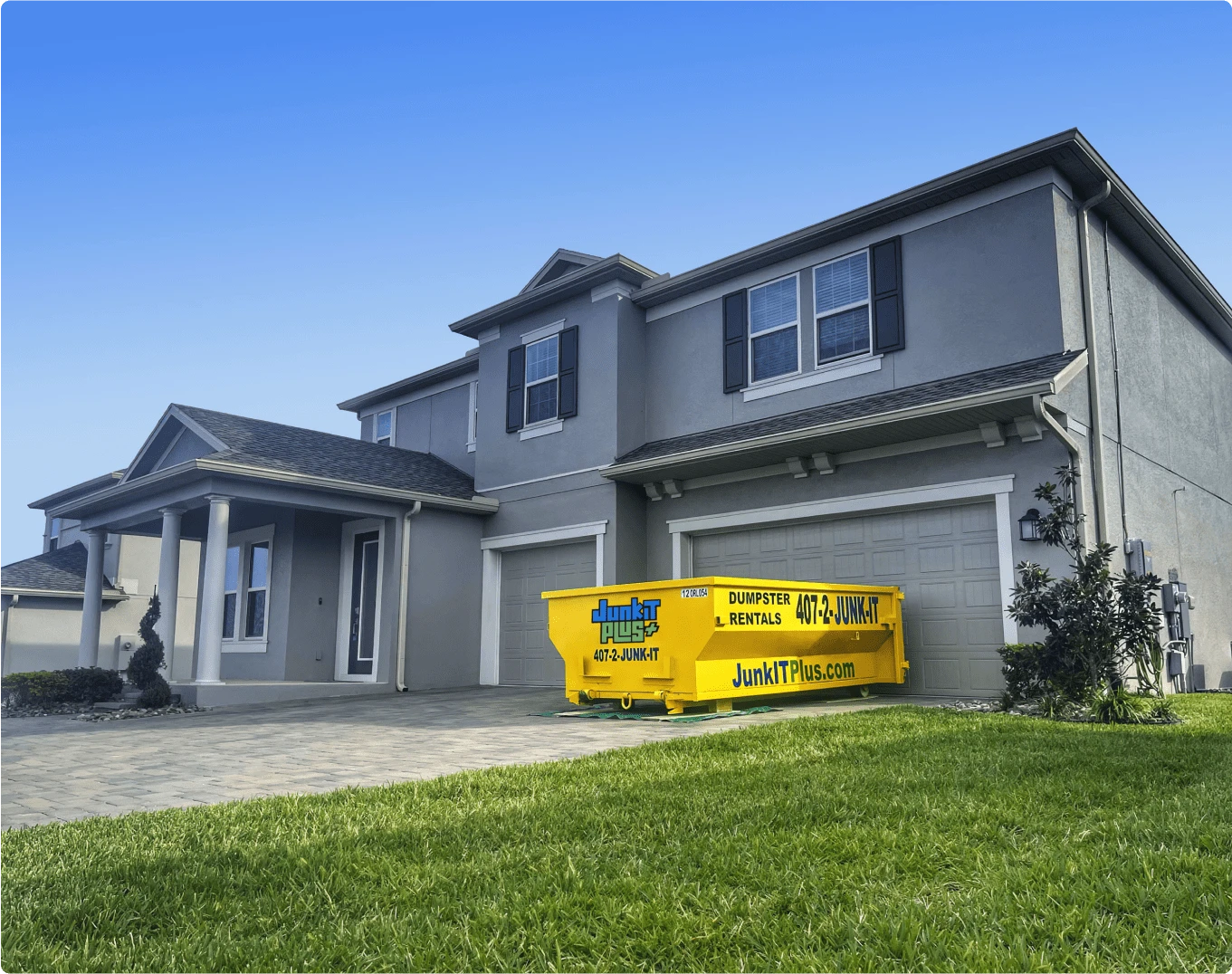 JUNKIT PLUS DUMPSTER IN FRONT OF HOUSE