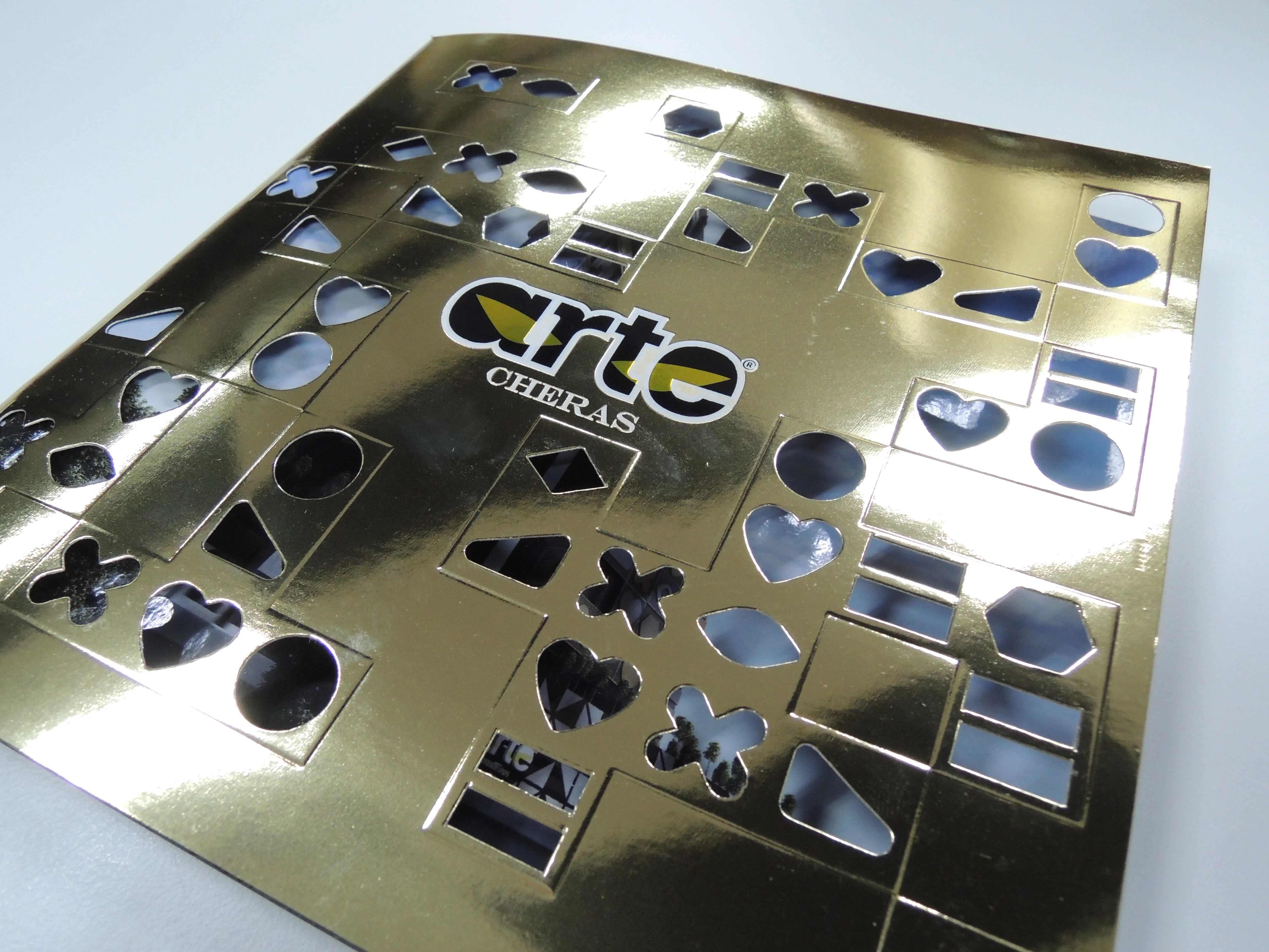 The perforated champagne gold cover design was chosen for the final design