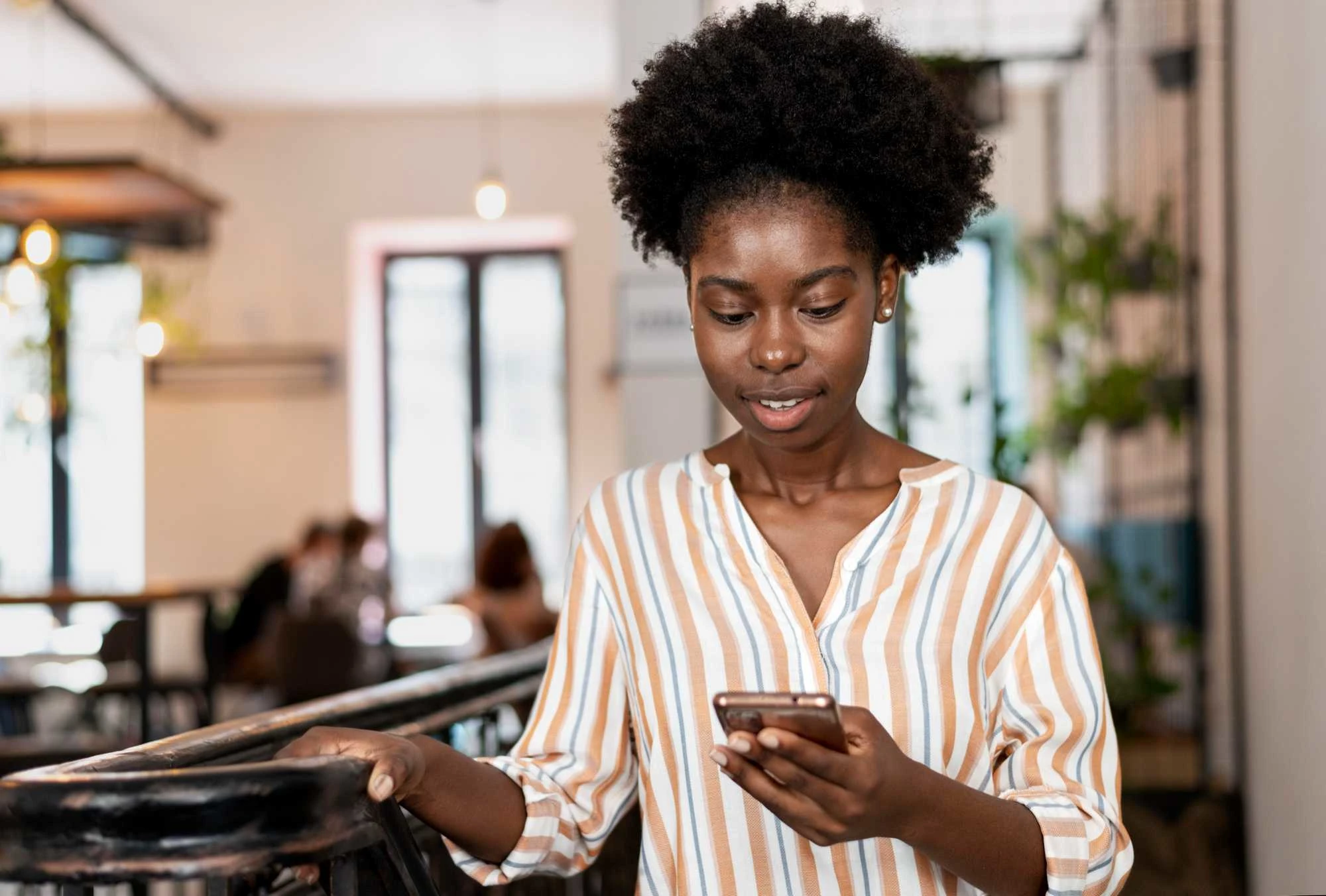 A young entrepreneur accessing a mobile device to make payment