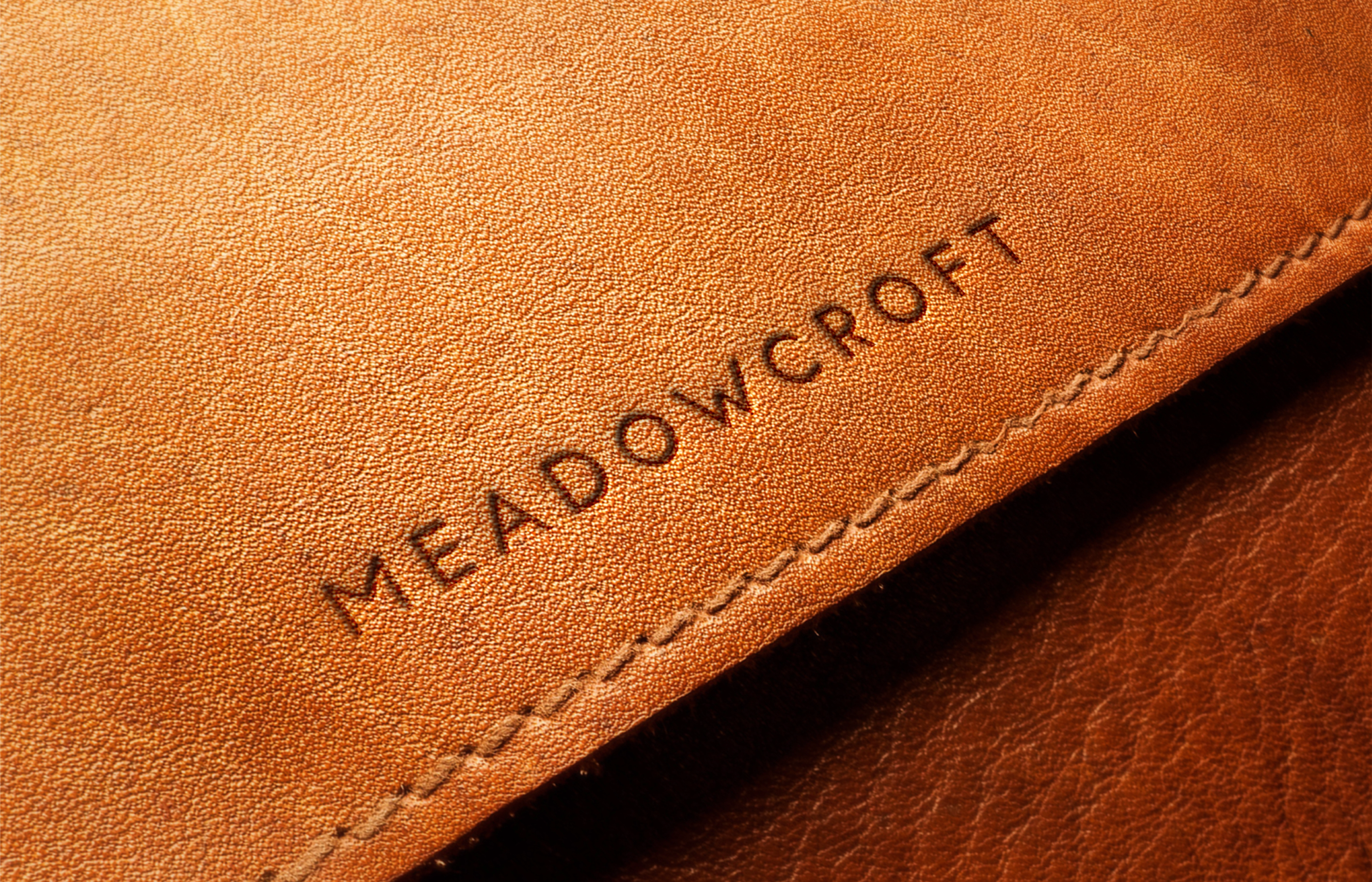 Application of the wordmark on the product/leather. 