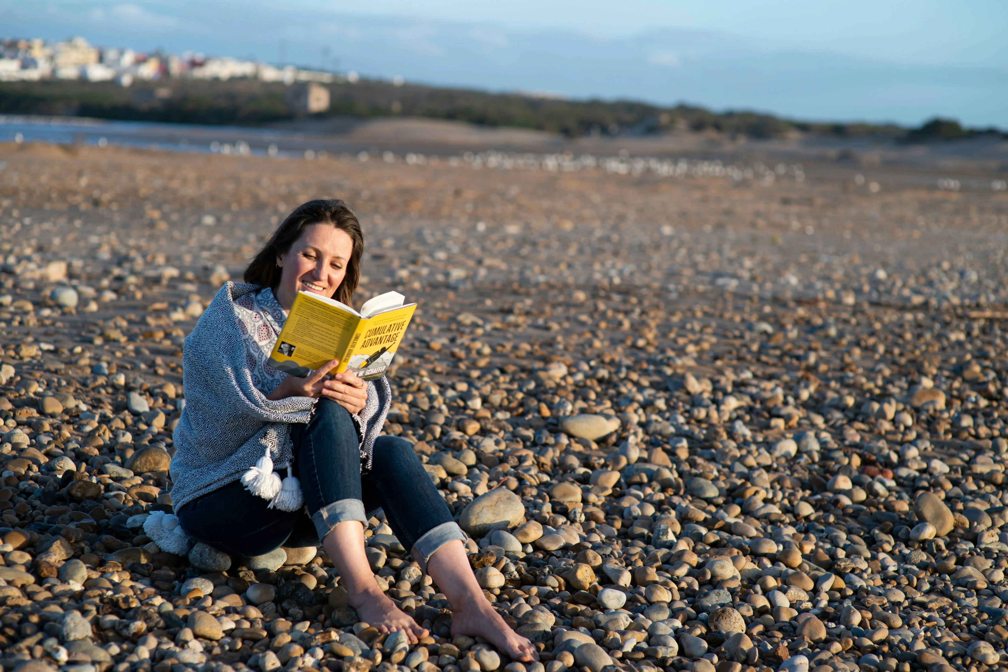 Girl reading a book with the smiling face Photo by Irina Leoni on Unsplash