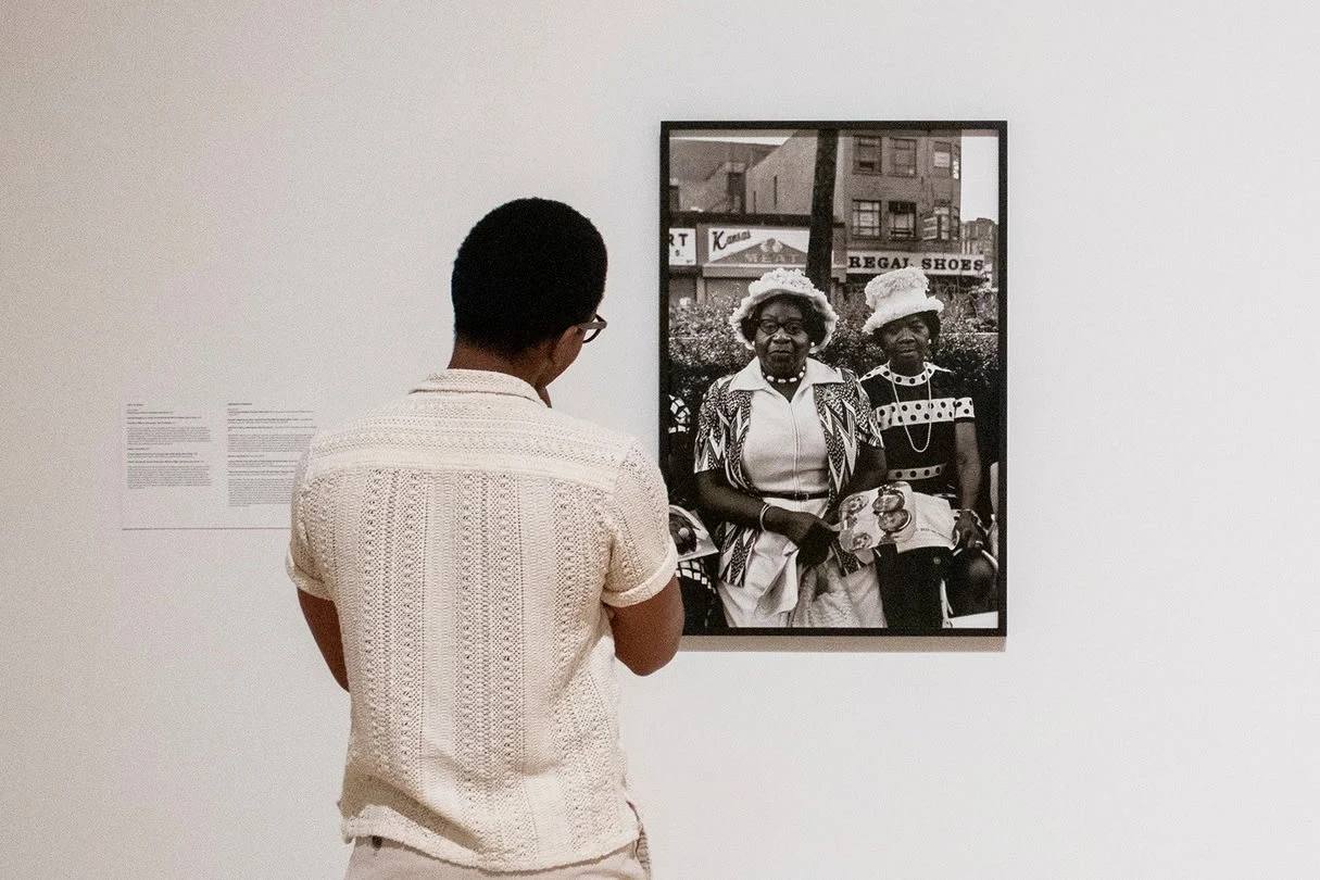 A visitor looking at artwork featured in Ming Smith: Feeling the Future (2023). Photography by Victoria Nguyen.