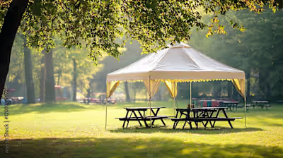 Small marquee tent with picnic tables in a park isolated on a c…