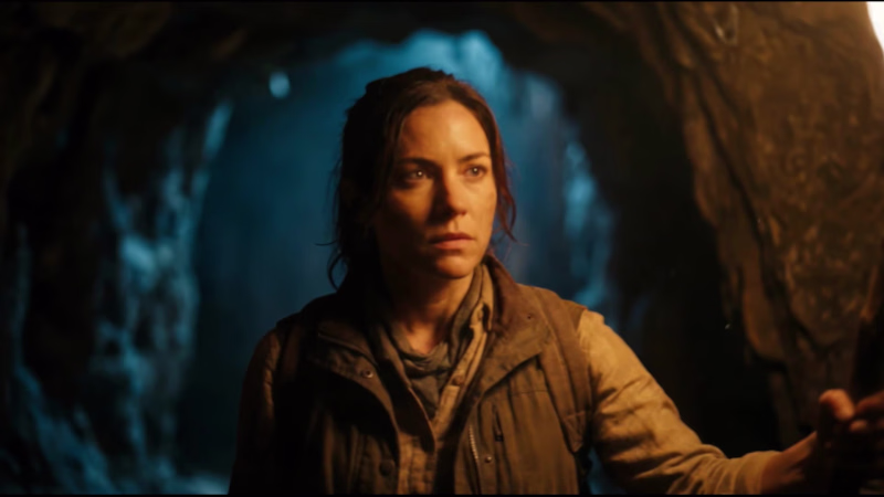 Cover image for A female explorer moves through